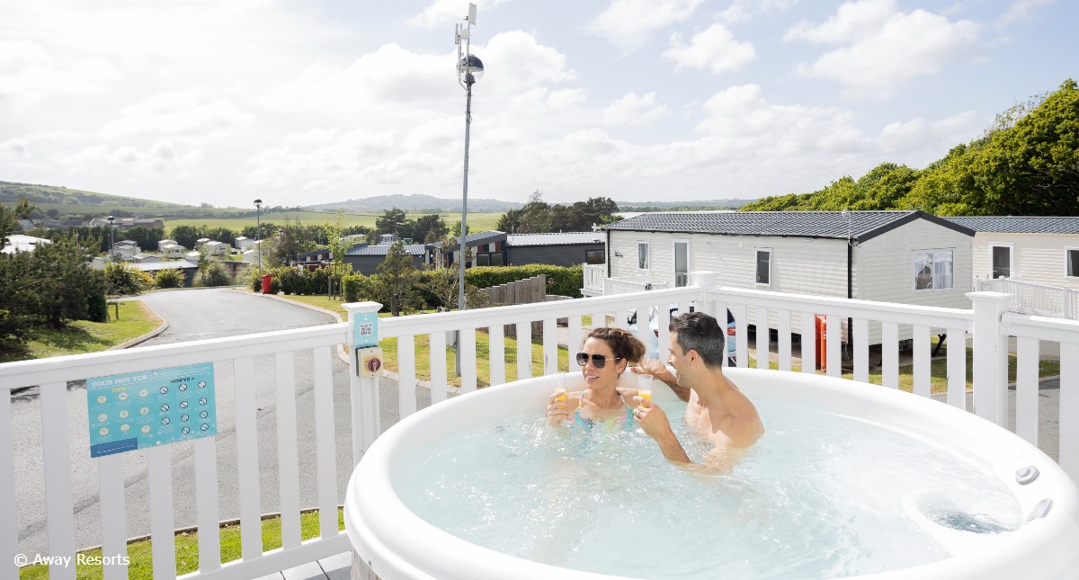 Couple in hot tub at Away Resorts on the Isle of Wight